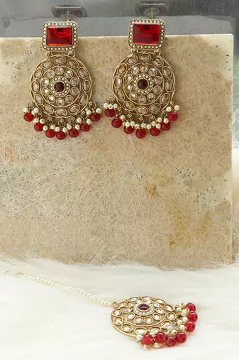 Kundan danglers with red beads and stone accents