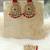 Kundan danglers with red beads and stone accents