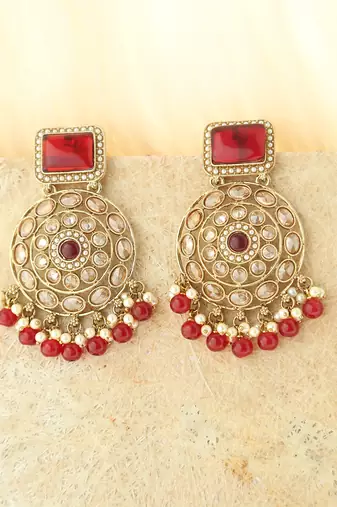 Kundan danglers with red beads and stone accents