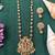 Antique gold plated temple necklace set featuring divine motifs and artistic craftsmanship perfect for festive occasions
