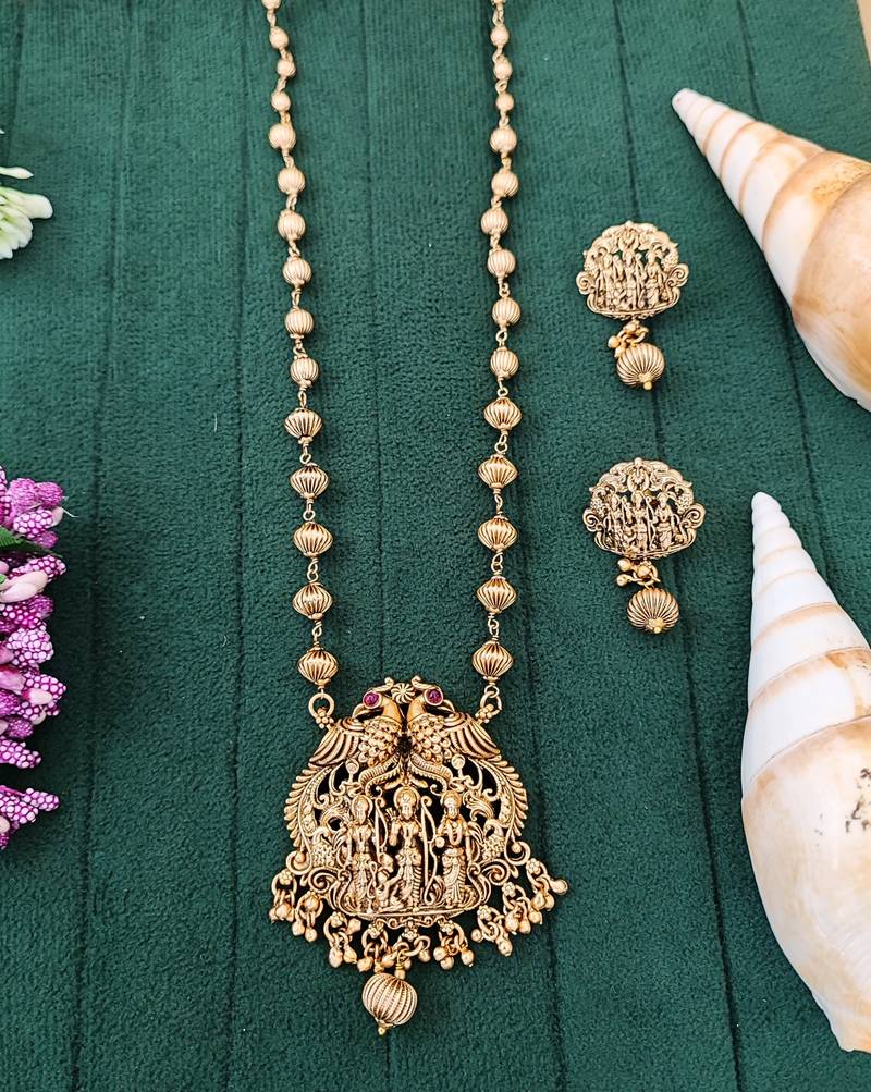 Antique gold plated temple necklace set featuring divine motifs and artistic craftsmanship perfect for festive occasions