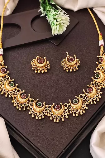 Gold plated necklace and earrings set with crescent motifs and multicolored stones – perfect for festive and ethnic wear