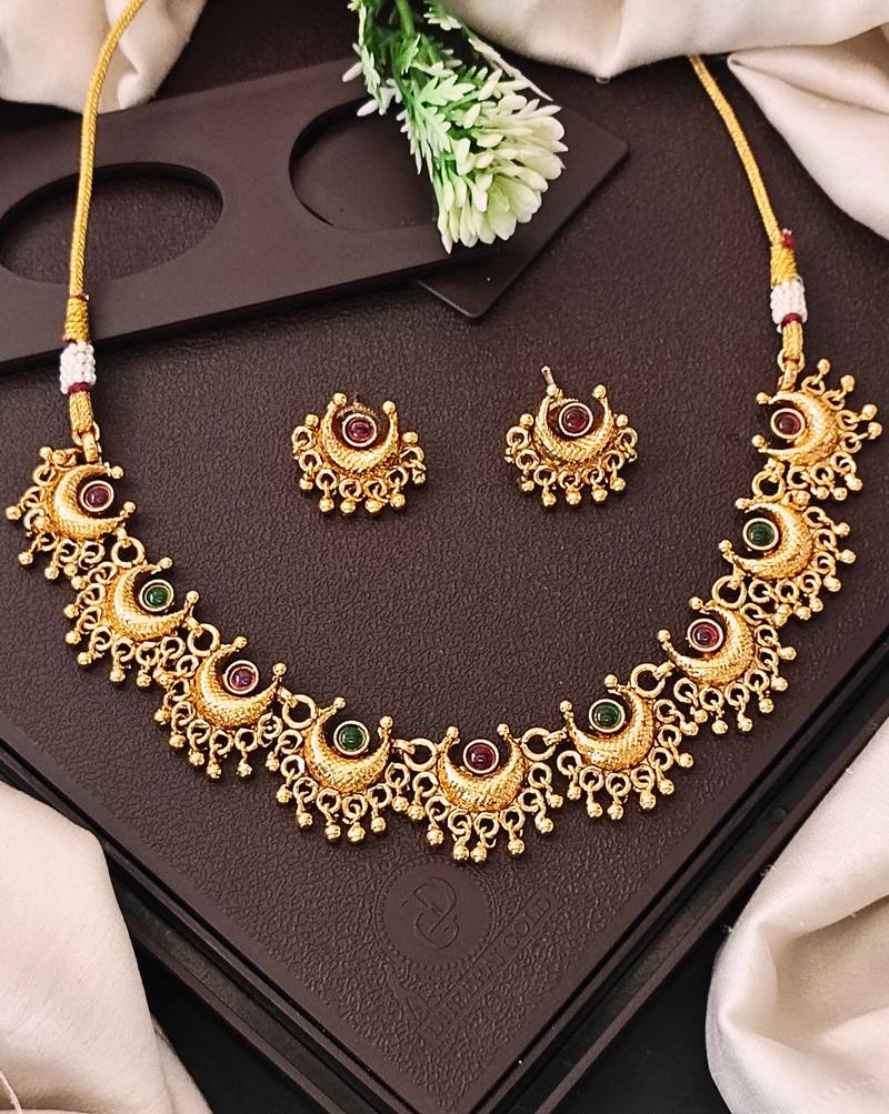 Gold plated necklace and earrings set with crescent motifs and multicolored stones – perfect for festive and ethnic wear