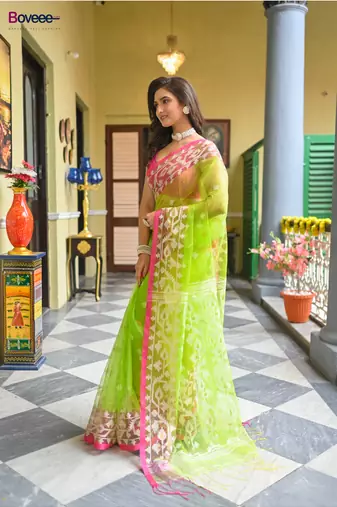Green  muslin silk blend saree with pink border and woven motifs