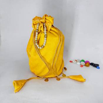 Yellow plain with sikka zumkha lace on bottom round potli 2