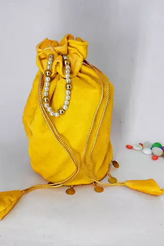 Yellow plain with sikka zumkha lace on bottom round potli
