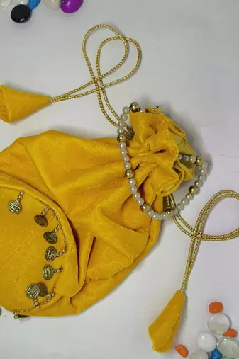 Yellow plain with sikka zumkha lace on bottom round potli