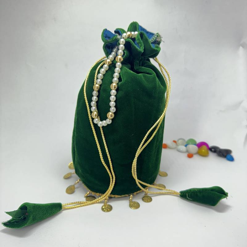 Green plain with sikka zumkha lace on bottom round potli