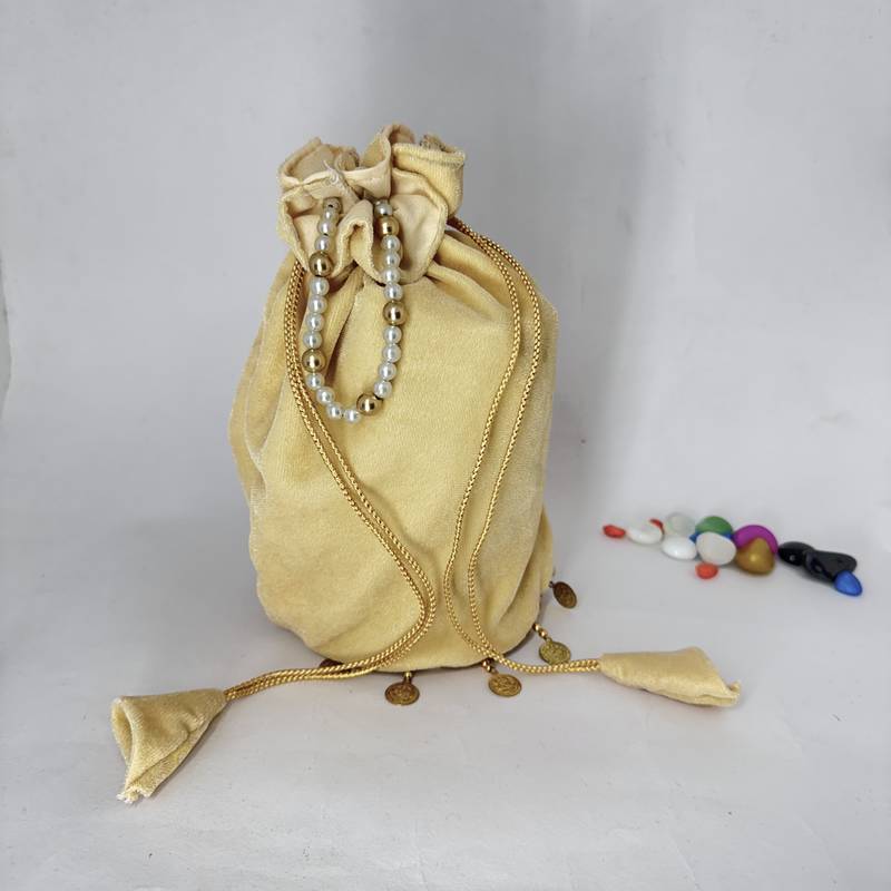 Cream plain with sikka zumkha lace on bottom round potli