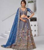 Teal Blue Raw Silk Bridal Lehenga Featuring Temple, Cow & Floral Embroidery