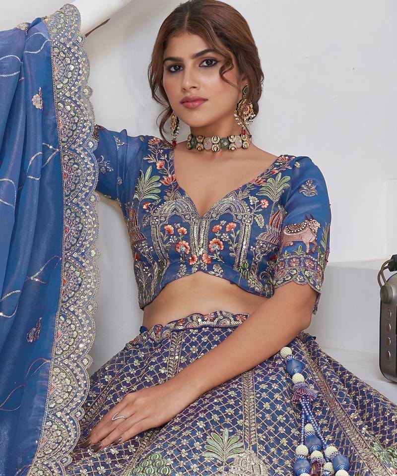 Teal Blue Raw Silk Bridal Lehenga Featuring Temple, Cow & Floral Embroidery