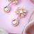 Women drop earrings in rose gold finish with diamond stones