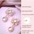 Women drop earrings in rose gold finish with diamond stones