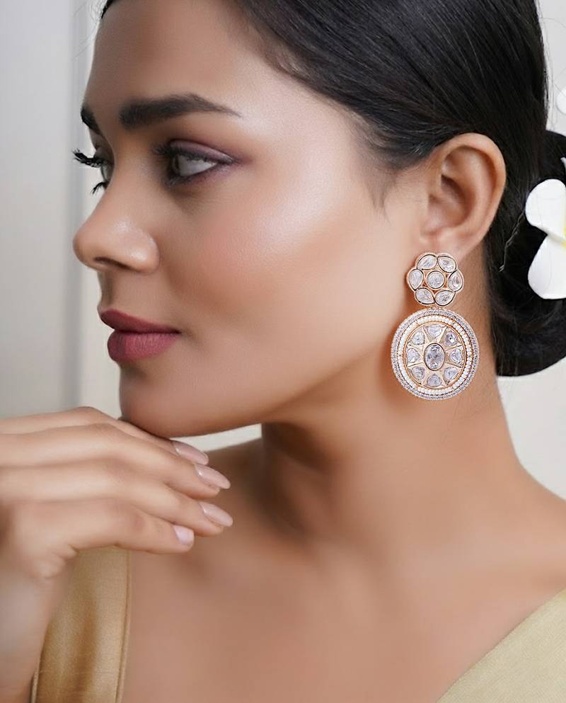 Women gold finish earrings featuring sparkling diamond embellishments