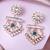 Women gold-plated ethnic dangle earrings with green kundan and bead embellishments