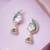 Women gold tone earrings adorned with green semi precious stones