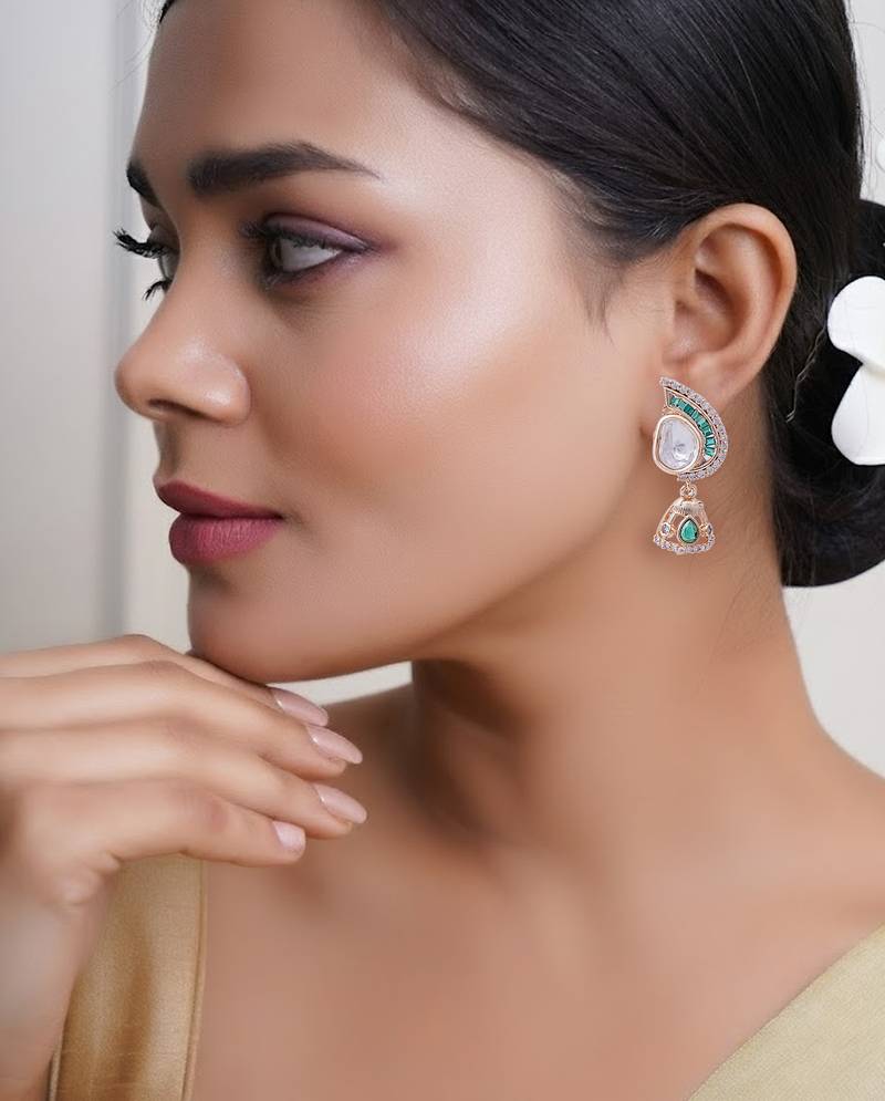 Women gold tone earrings adorned with green semi precious stones
