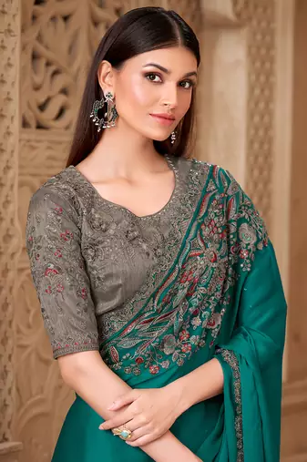 Teal color satin silk blend embroidered border saree