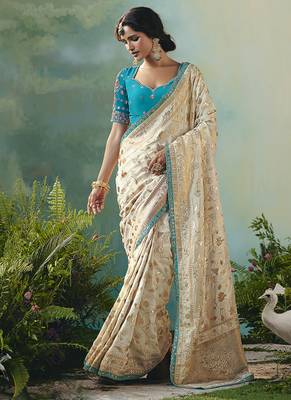Off white dola viscose silk blend saree with zari weaving & sequence work blouse 1