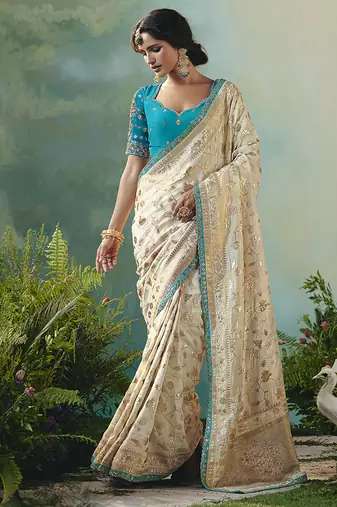 Off white dola viscose silk saree with zari weaving & sequence work blouse