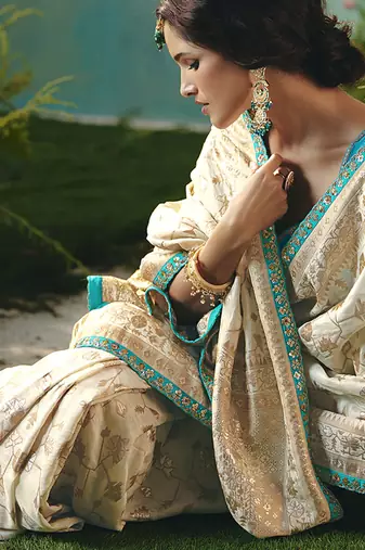 Off white dola viscose silk blend saree with zari weaving & sequence work blouse