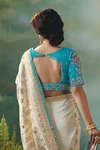 Off white dola viscose silk blend saree with zari weaving & sequence work blouse