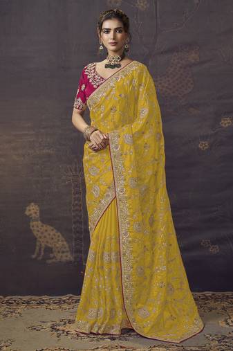 Yellow party wear heavy organza saree with designer blouse fabric