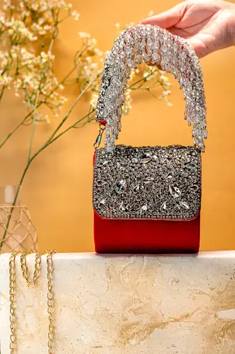 Red stone embroidered clutch