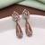 Orange color american diamond earrings