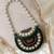 metal mirage green, ivory & multi concentric motif embellished clutch