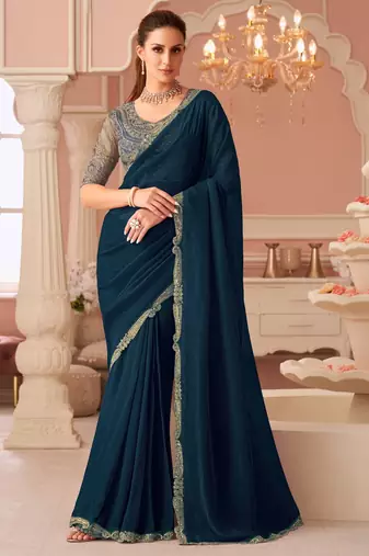 Teal georgette saree with heavy embroidered blouse and designer lace border  for weddings & special occasions
