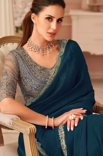 Teal georgette saree with heavy embroidered blouse and designer lace border  for weddings & special occasions