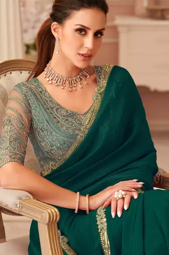 Green georgette saree with heavy embroidered blouse and designer lace border  for weddings, festive celebrations