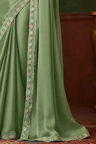 Green satin saree, lace border with heavy embroidered blouse for special occasions