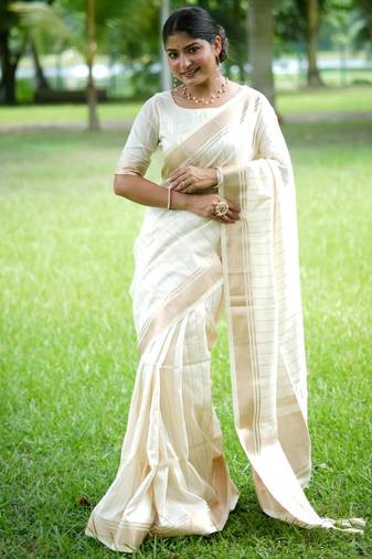Off-white banarasi raw silk saree with zari lining weaving, premium zari border & running blouse