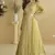 Lemon yellow chinon silk embroidered designer gown with strug