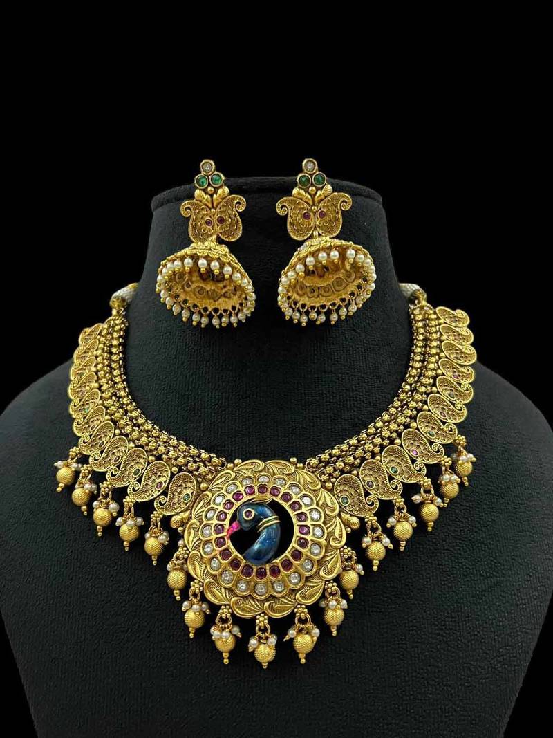 Majestic gold-toned peacock pendant antique kundan necklace set with jhumka earrings