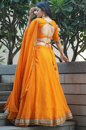 ORANGE ZARI AND CODING LACE WORK WITH LEHERIYA PRINTED GEORGETTE PARTY SEMI STITCHED LEHENGA CHOLI