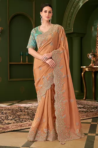 Light orange color  faux georgette silk embroidered saree with heavy work blouse