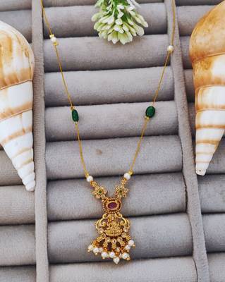 Antique gold lakshmi pendant chain with pearls and green stones for traditional and festive wear 1