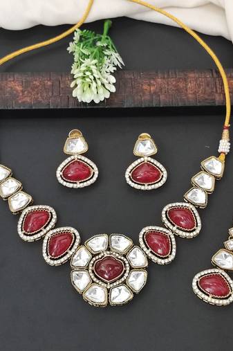 Red stone kundan necklace set with mirror-cut detailing, elegant bridal jewellery with matching earrings