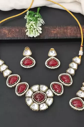 Red stone kundan necklace set with mirror-cut detailing, elegant bridal jewellery with matching earrings
