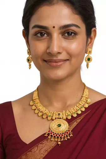temple necklace set with green and ruby stones, intricate detailing and matching earrings
