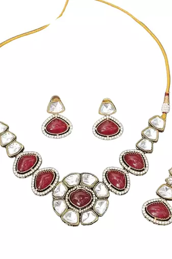 Red stone kundan necklace set with mirror-cut detailing, elegant bridal jewellery with matching earrings