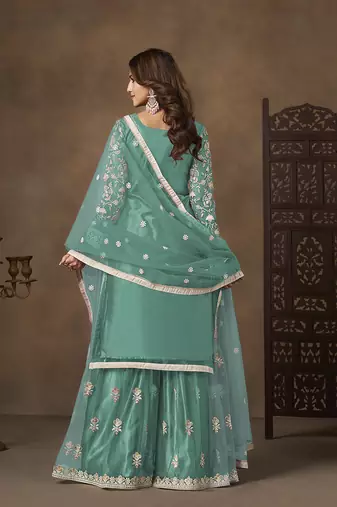 Net embroidered turquoise salwar kameez