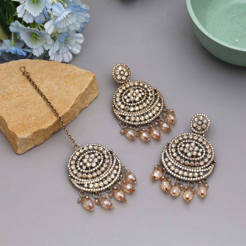 Gold color kundan earrings tikka set
