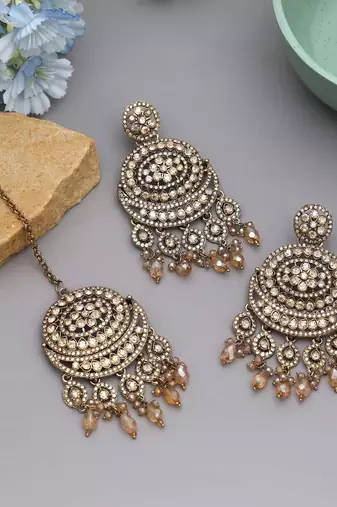 Gold color kundan earrings tikka set