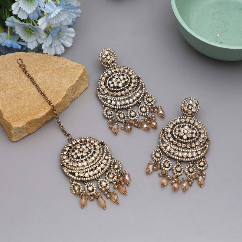 Gold color kundan earrings tikka set