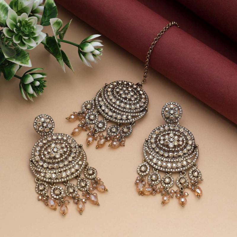 Gold color kundan earrings tikka set