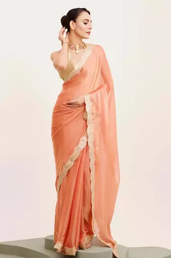 Peach solid satin saree with embellished border